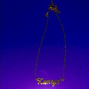 Necklace says Kamryn with a heart.